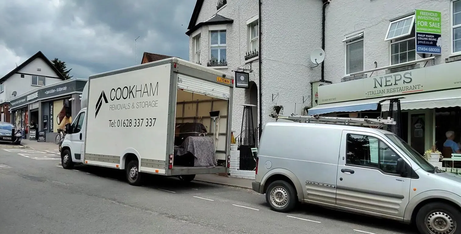 The Cookham Removals & Storage van parked on a high street with shop fronts