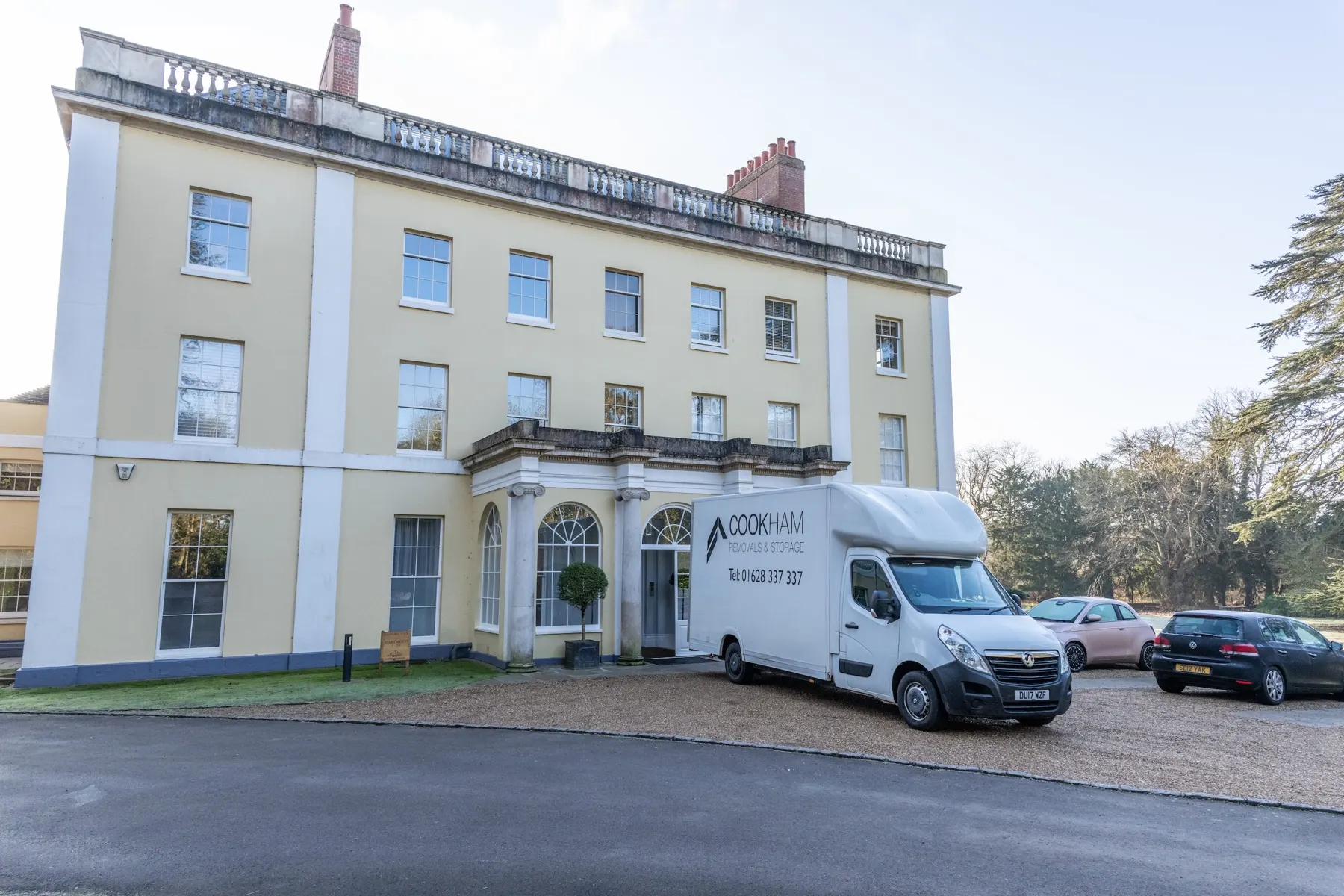 Yellow-rendered Georgian house seen from the gravel drive with the Cookham Removals & Storage Luton van parked at the entrance