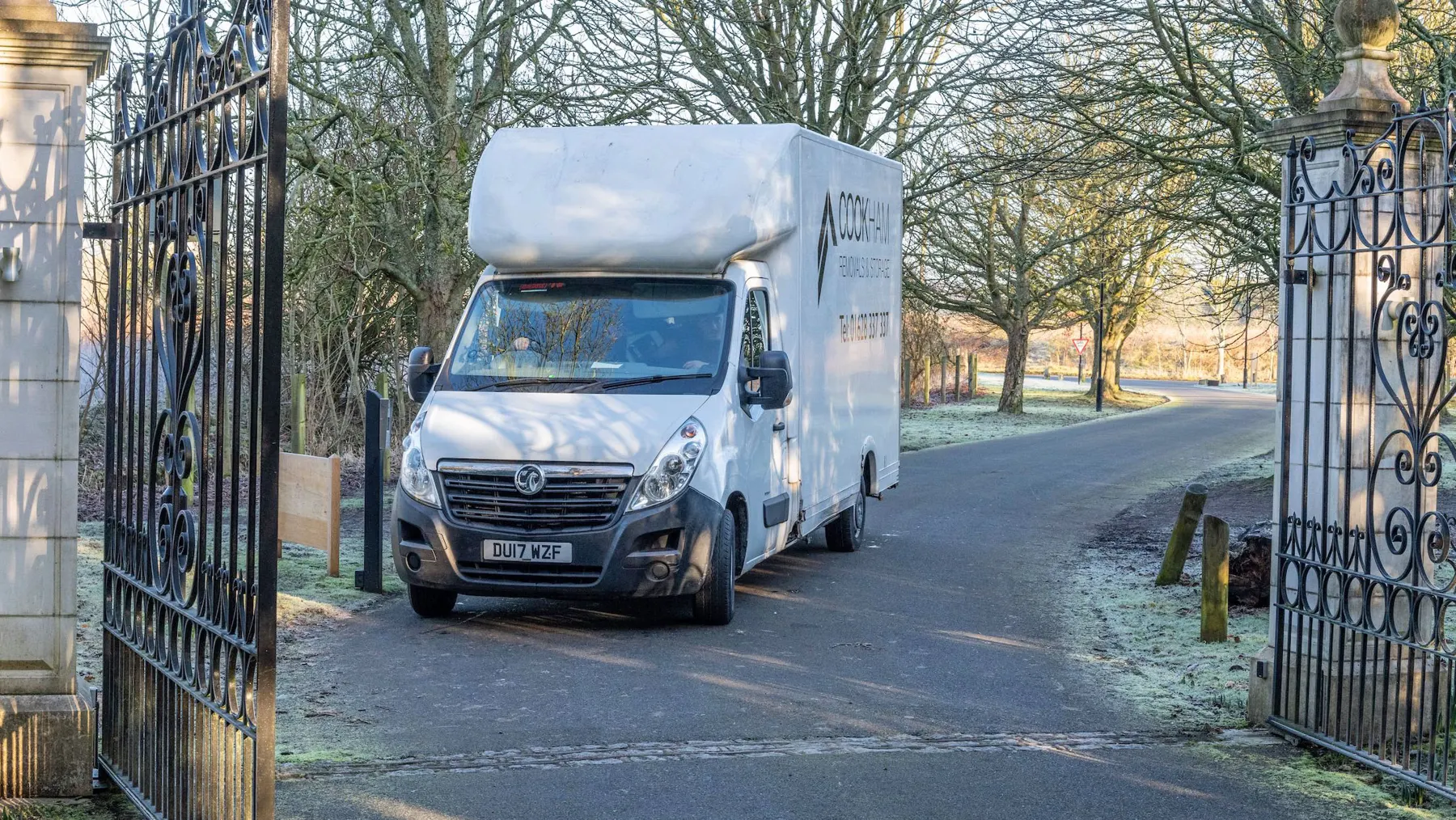 Cookham Removals & Storage Luton van on a lane bordered by frosty grass and iron gates