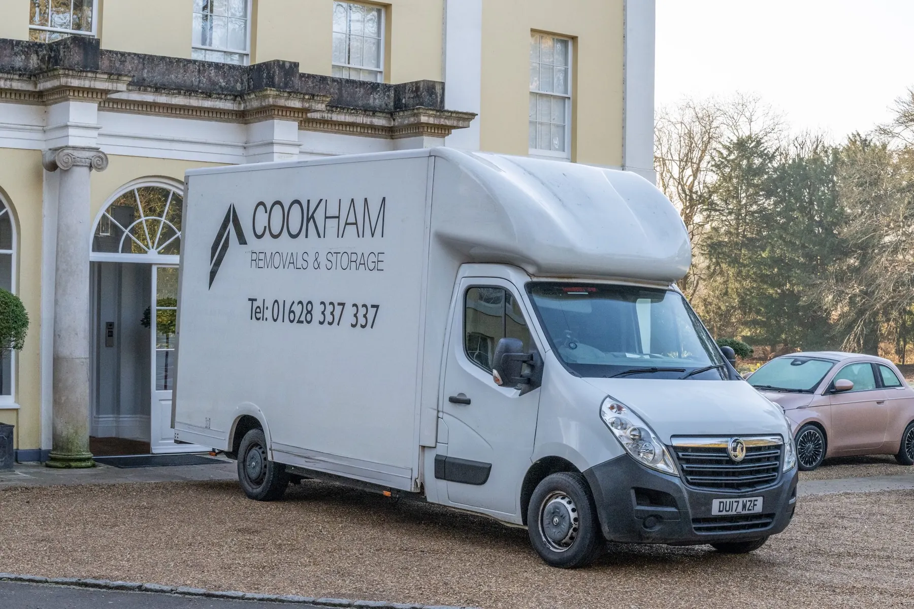 White Luton van with Cookham Removals & Storage livery parked outside a yellow-rendered Georgian house with a pillared porch