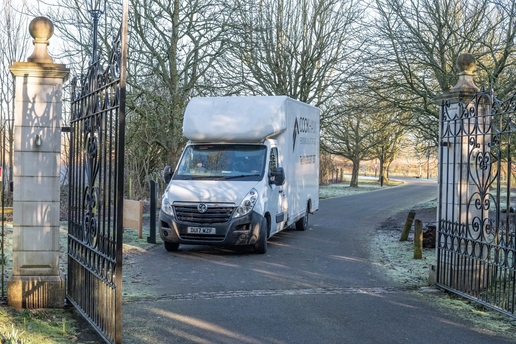Cookham Removals & Storage Luton van driving through open iron gates between stone pillars