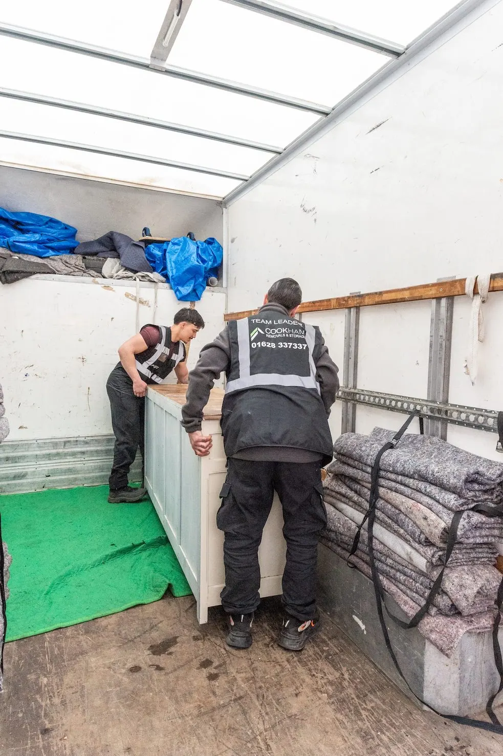 Cookham Removals & Storage crew inside the Luton van wrapping items in removal blankets